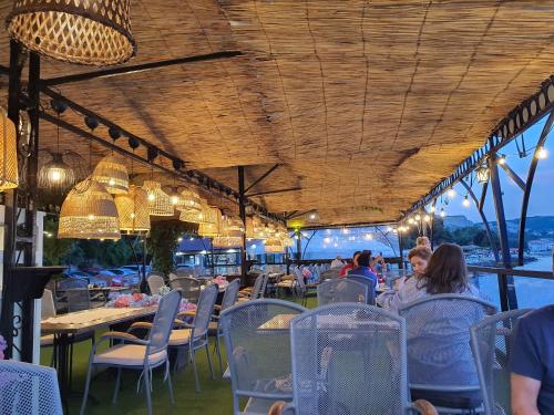 a restaurant with people sitting at tables and chairs at Regina Maria Spa Design Hotel in Balchik