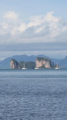 two islands in the water with boats in the water at Touch Glamping Koh Yao Noi ทัช แกรมปิ้ง เกาะยาวน้อย in Ko Yao Noi
