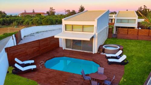 a house with a swimming pool in the yard at Cocoon Luxury Villas in Maleme