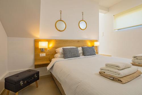 a bedroom with a large bed with towels on it at Cocoon Luxury Villas in Maleme