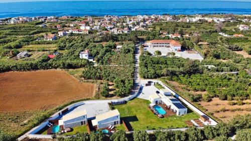an aerial view of a house with the ocean at Cocoon Luxury Villas in Maleme