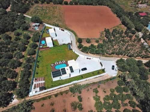 an overhead view of a large white house on a field at Cocoon Luxury Villas in Maleme