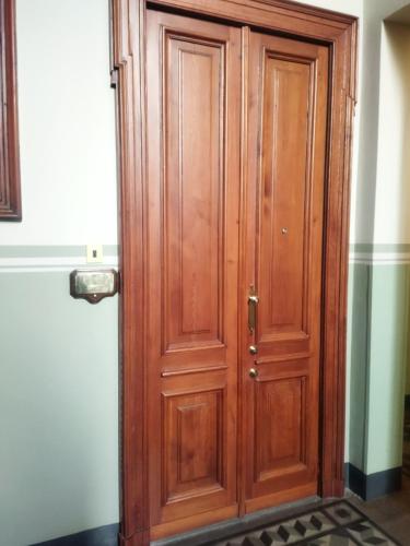a wooden door in the corner of a room at Loft Crocetta in Turin