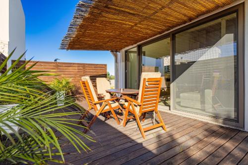 a patio with a table and chairs on a deck at Cocoon Luxury Villas in Maleme