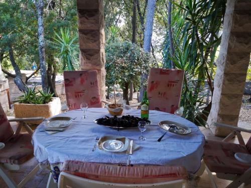 a table with a blue table cloth and a bottle of wine at Holiday Home Božo in Korčula