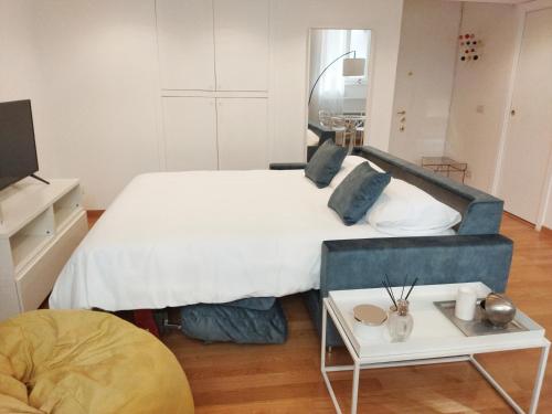 a bedroom with a large bed and a table at Loft Crocetta in Turin