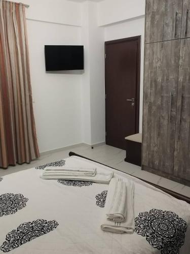 a bedroom with a bed with towels on it at Villa Miron in Kamilari