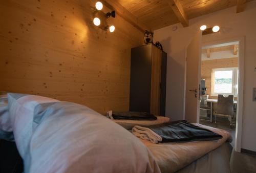 a bedroom with two beds in a room with wooden walls at Blaues Ferienhaus Wernigerode in Wernigerode