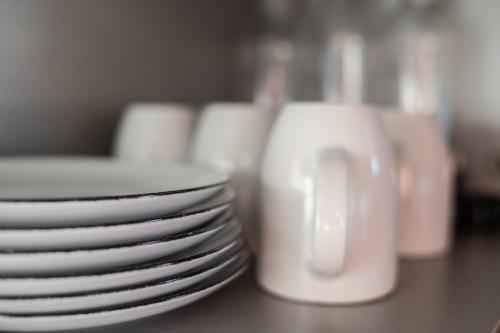 a stack of white plates sitting on a table at Blaues Ferienhaus Wernigerode in Wernigerode