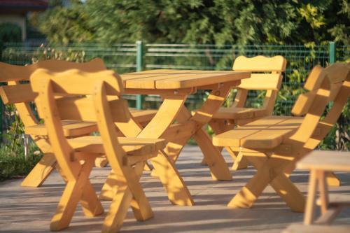 a wooden picnic table and two chairs on a patio at Blaues Ferienhaus Wernigerode in Wernigerode