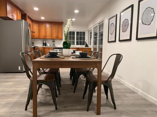 a kitchen with a table with chairs and a refrigerator at @ Marbella Lane - 4BR Alluring Home in Union City