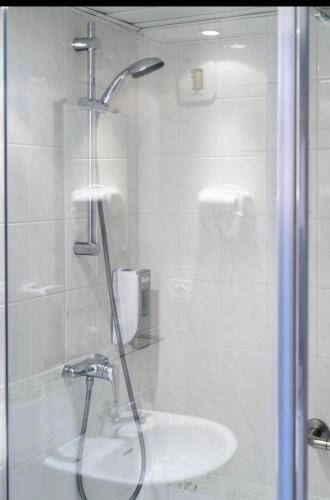 a bathroom with a shower and a sink at Grand Hôtel d'Espagne in Lourdes
