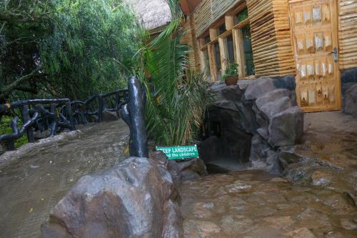 a sign on a rock in front of a house at Dovenest Lodge in Naivasha