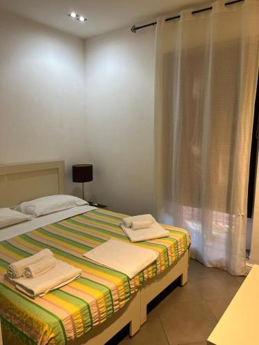 a bedroom with a bed with two towels on it at Casual Stay Galileo in Reggio Calabria