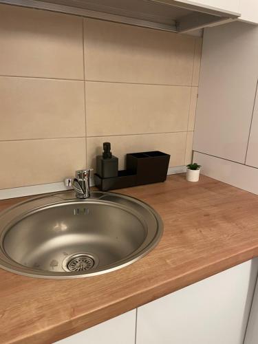 a bathroom sink with a faucet on a counter at Studio Confort 4 in Bucharest