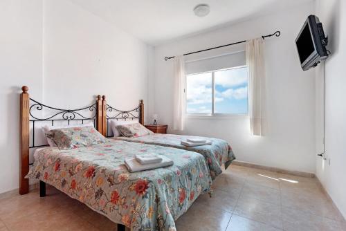 En eller flere senge i et værelse på Rincón Triana