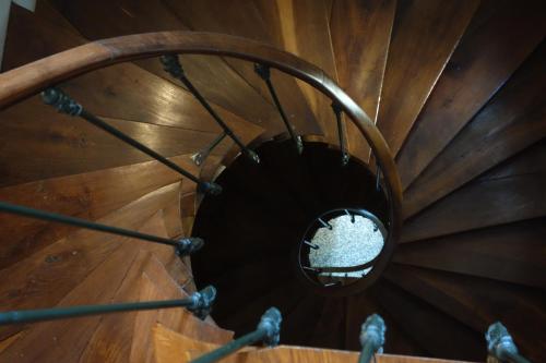 an overhead view of a wooden spiral staircase at Le Fassardy in Châteauroux