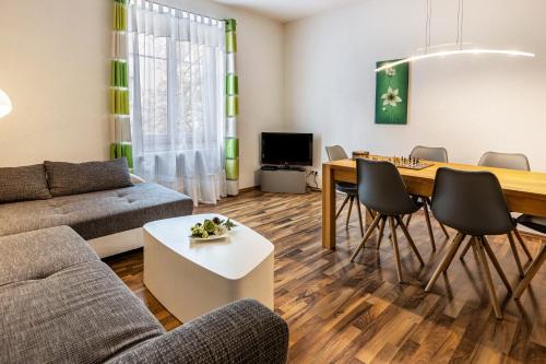 a living room with a couch and a table at Ferienwohnung Stachel B in Konstanz