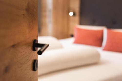 a room with a bed with red pillows at Apartement Almhof Fiss in Fiss