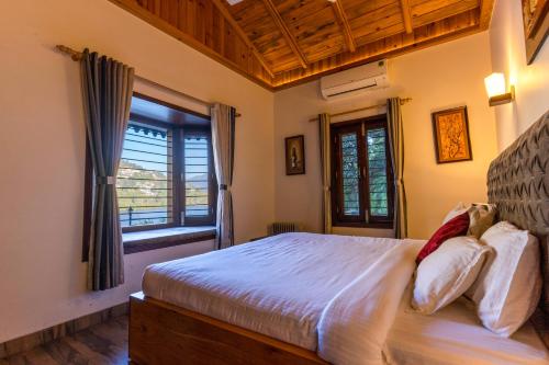 a bedroom with a large bed and a window at SaffronStays Gardens On The Lake, Bhimtal - pet-friendly garden villa by the lake in Bhīm Tāl