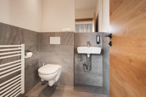 a bathroom with a toilet and a sink at Apartement Almhof Fiss in Fiss