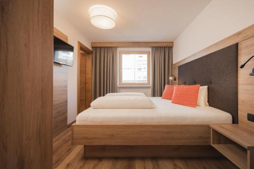 a bedroom with a bed and a window at Apartement Almhof Fiss in Fiss