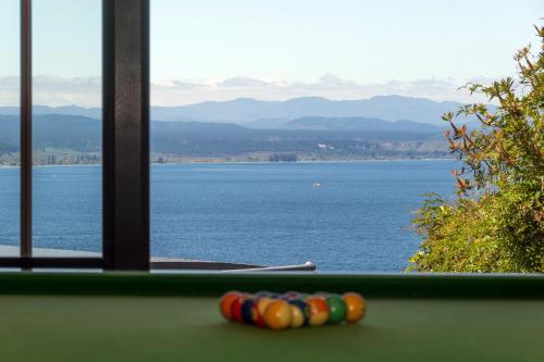 a pool table with a view of the water at The Flying Trout Boutique Lodge in Taupo