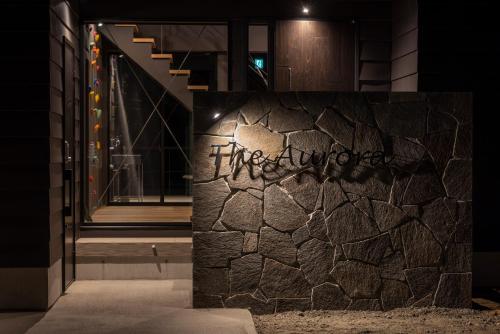 a stone wall with the word sqor written on it at Hakuba Aurora Chalet by Jade Group in Hakuba
