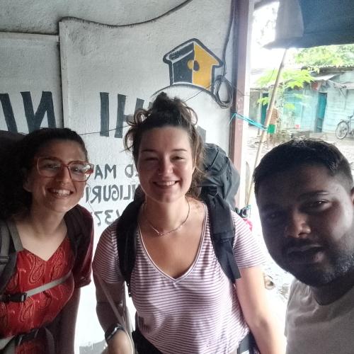 a woman and two men standing in front of a building at Atathi Niwas Guest House for Backpackers and Travellers in Siliguri