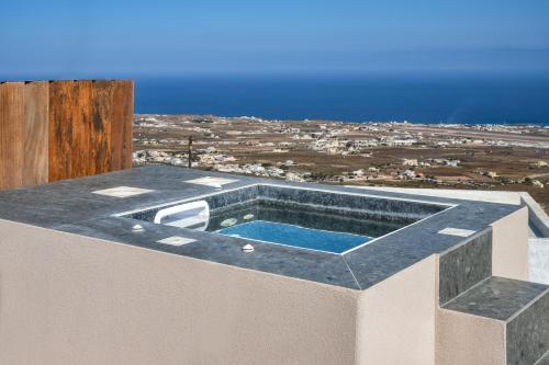 a swimming pool on the roof of a house at Santorini Soul Villas in Pirgos