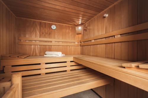 a sauna with wooden paneling and wooden shelves at Apartement Almhof Fiss in Fiss
