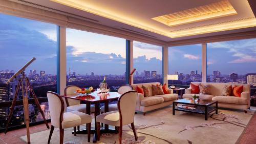 a living room with a view of a city at The Peninsula Tokyo in Tokyo
