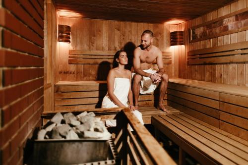 a bride and groom standing in a sauna at Atmoszféra Apartman in Sárvár