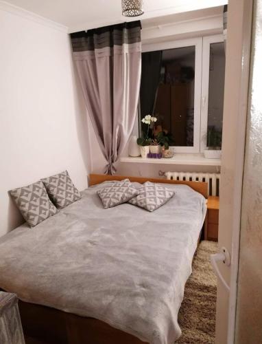 a bed in a room with a window at Apartament Jarosław na wyłączność in Jarosław