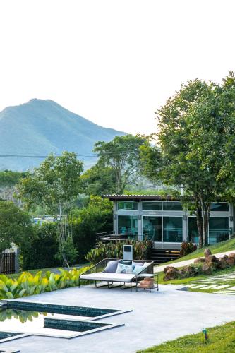 a house with a bench and a table in front at Mighty Mountain Thailand in Kaeng Krachan
