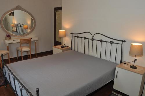 a bedroom with a bed and a mirror and a desk at Vila Vasi- Μodern maisonette view Meteora in Kastraki