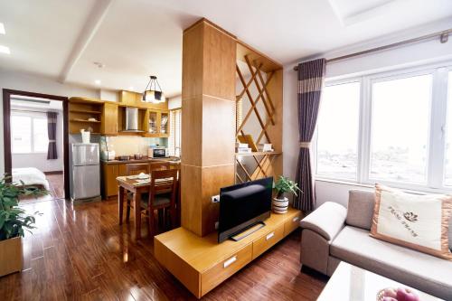 a living room with a couch and a tv at Trang Thanh Luxury Apartment in Hai Phong