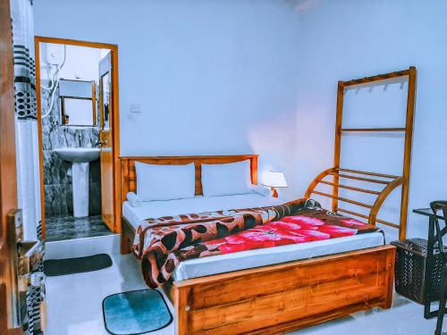 a bedroom with a bed and a mirror and a sink at Heaven Hills Guest House in Maskeliya