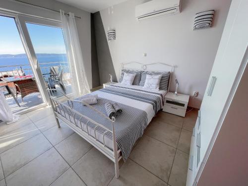 a bedroom with a bed with a view of the ocean at Ferienhaus Ivanka in Trogir