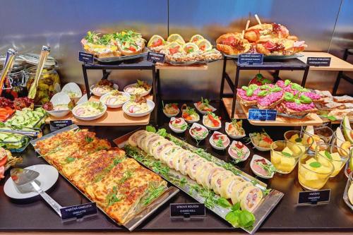 a buffet with many different types of food on display at Wellness Hotel Fénix in Liberec