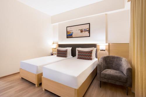 Postel nebo postele na pokoji v ubytování Keys Lite By Lemon Tree Hotels Sreekanya
