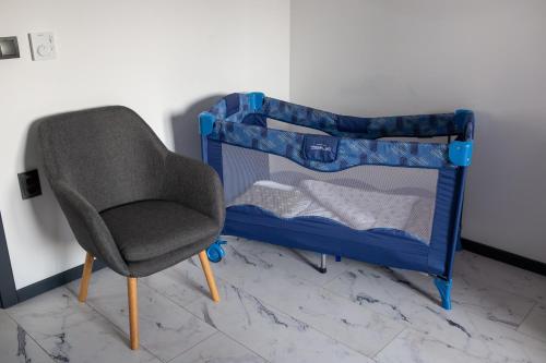 a chair and a bunk bed in a room at RUBO Hotel in Shumen