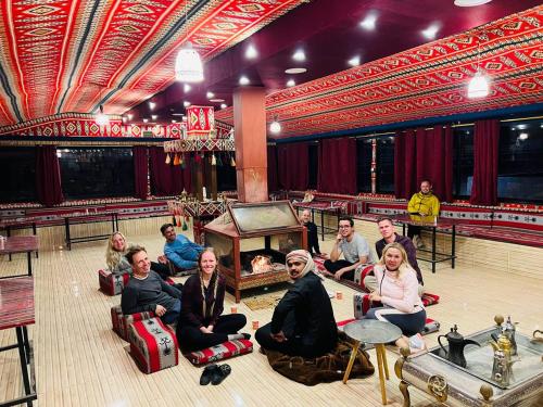 a group of people sitting in chairs in a theatre at Joy to Wadi Rum in Wadi Rum