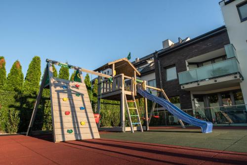 an outdoor playground with a slide and a ladder at R31 Residence in Sárvár
