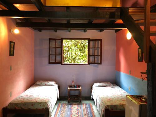 Postel nebo postele na pokoji v ubytování Eco-Flats Cachoeira Azul