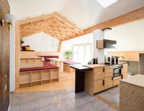 una cocina con armarios de madera y una isla de cocina en Montagu Hostel en Innsbruck