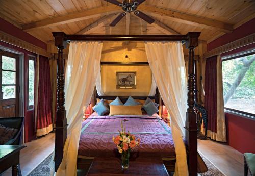 una camera con letto a baldacchino e soffitto in legno di Srinivas The Royal Residence, Jaipur a Jaipur