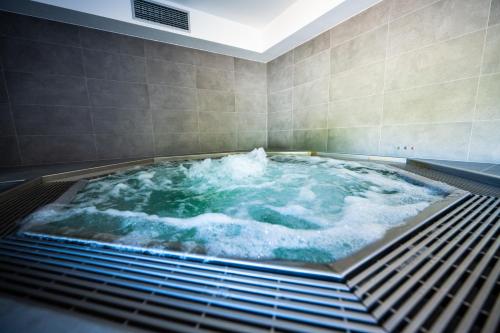 a jacuzzi tub with water in a room at Wellness & Spa Pila Kvilda AP 2 01 a AP 3 07 in Kvilda