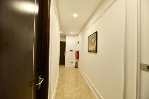 a hallway with a hallway leading to a room at Kingdom Hotel Hanoi in Hanoi