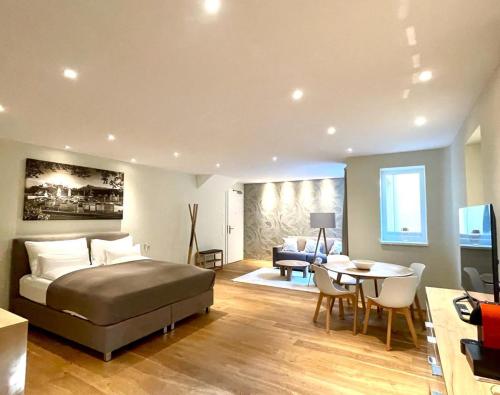 a bedroom with a bed and a living room at Villa Salzburg by Welcome to Salzburg in Salzburg